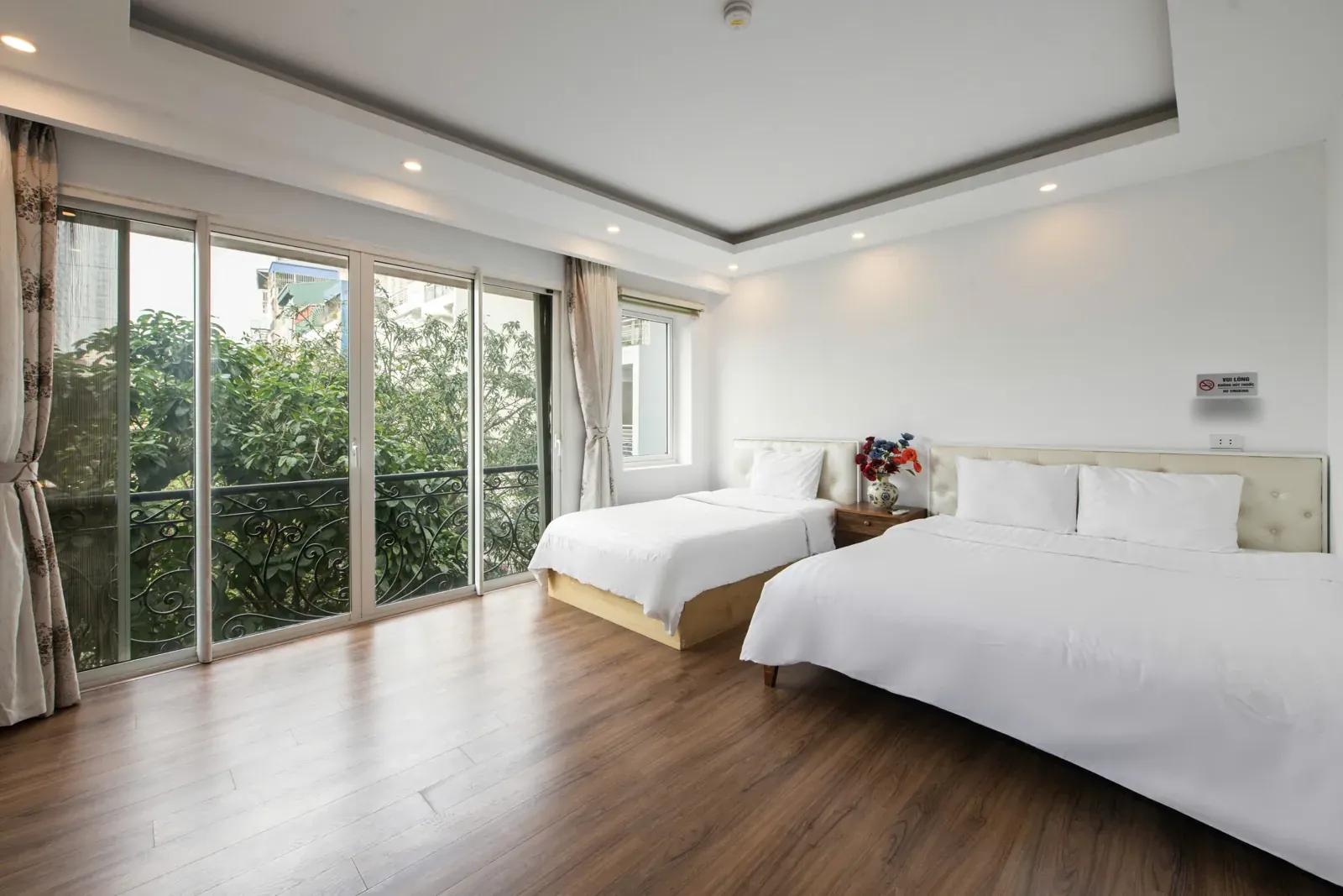 Apartment bedroom with floor-to-ceiling windows onto the trees